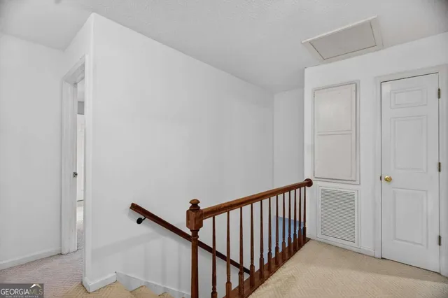 an empty room with a window and ceiling fan