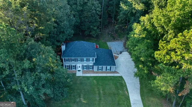 an aerial view of a house with a yard