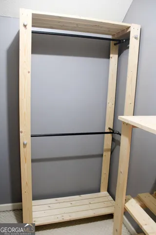 a view of a house with a yard chairs and a wooden fence