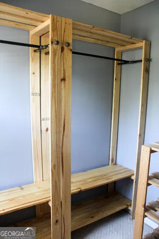 a backyard of a house with wooden floor and trees