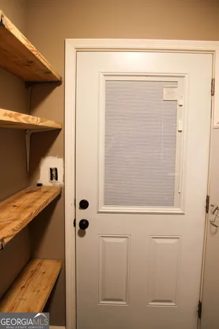 a view of wooden house with a large window