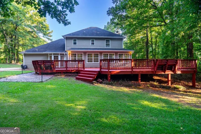 a view of a deck with wooden floor and fence