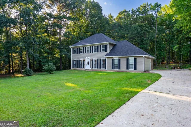 a front view of a house with a garden