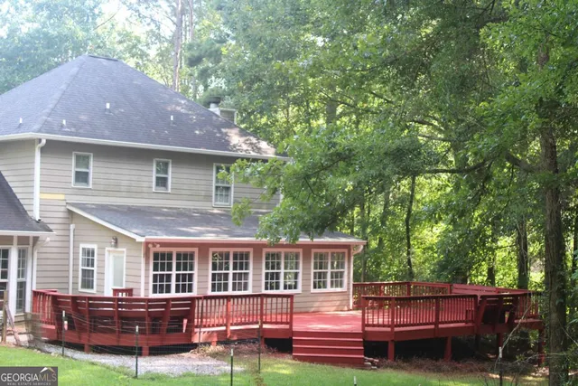a view of small yard with large trees