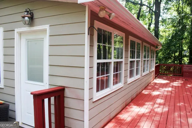 a wooden fence with trees in the background