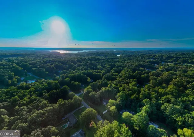 a view of an empty room with window and fire place
