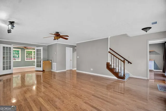 a view of an empty room with window and fireplace