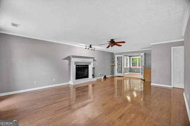a view of a room with wooden floor and window