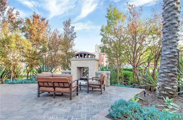 a view of a patio with table and chairs and potted plants