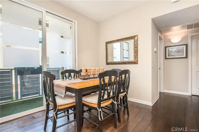 a dining room with furniture and wooden floor