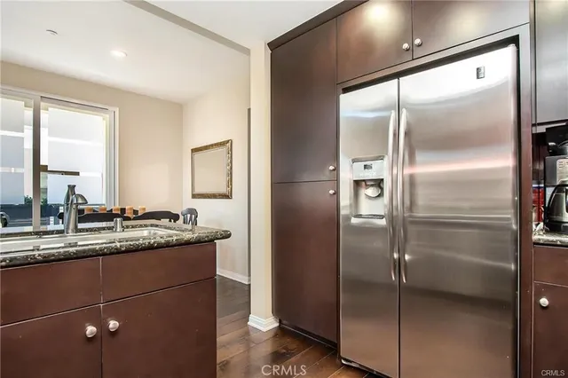 a kitchen with a refrigerator and a sink