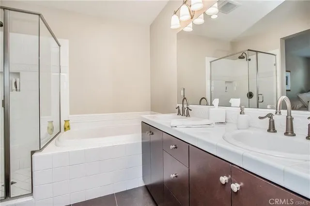 a bathroom with a tub a sink and mirror