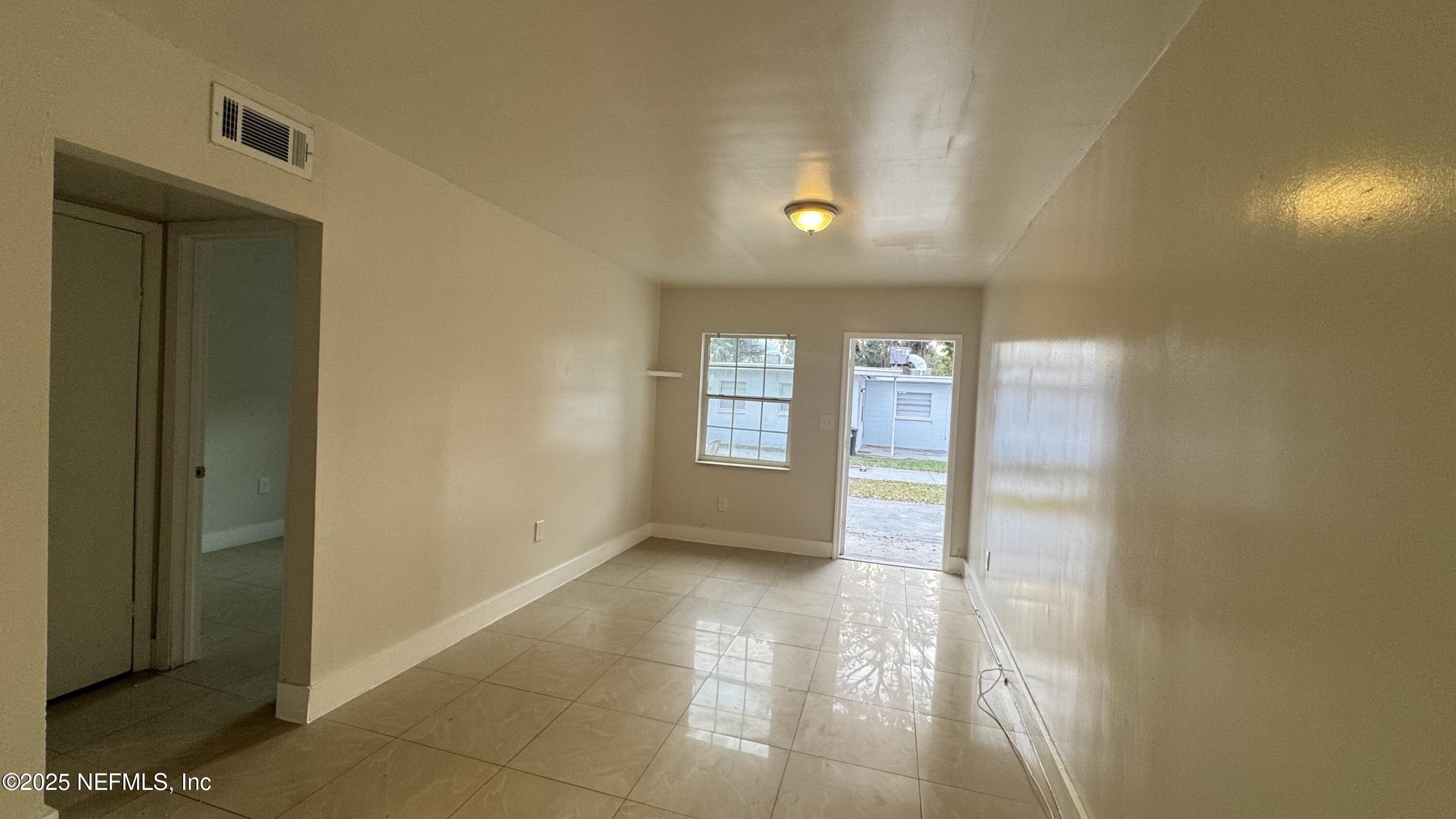 1052 Maynard Street, Unit 1044 Jacksonville, FL 32208 - Photo 2 of 7 a view of an empty room and window