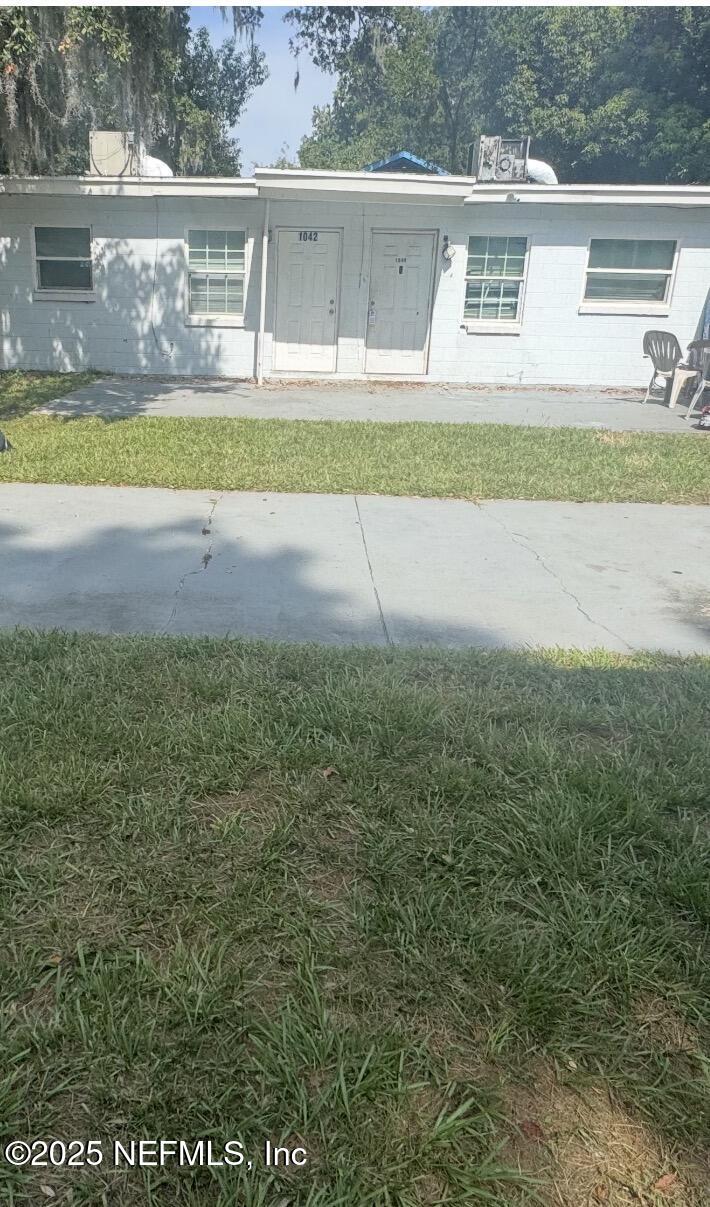 1052 Maynard Street, Unit 1044 Jacksonville, FL 32208 - Photo 4 of 7 a view of swimming pool with a yard and large tree