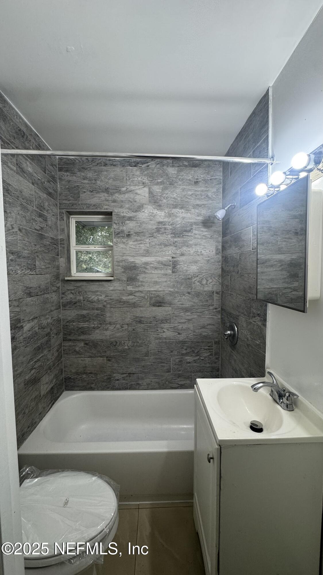 1052 Maynard Street, Unit 1044 Jacksonville, FL 32208 - Photo 6 of 7 a bathroom with a bathtub and a shower