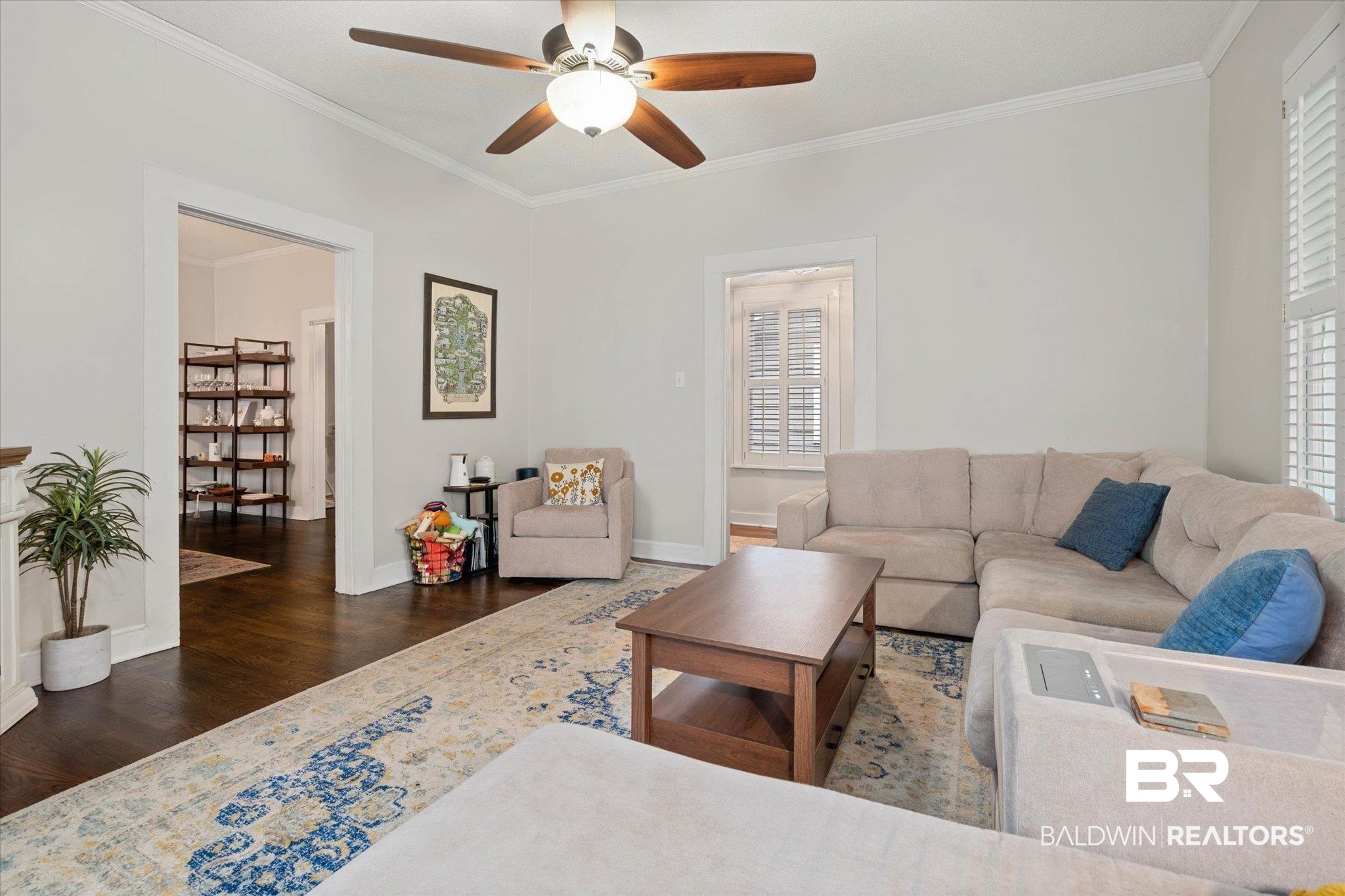 20 Hurlbert Street Mobile, AL 36607 - Photo 4 of 33 Living room featuring wood finished floors, ornamental molding, a ceiling fan, plenty of natural light, and baseboards