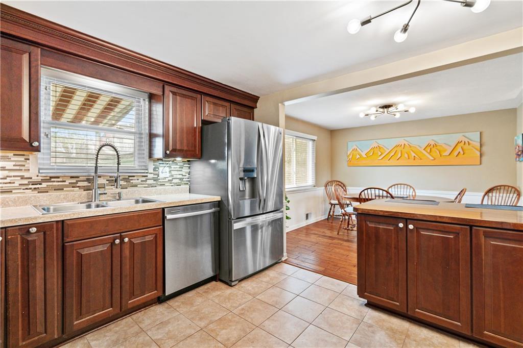 5140 Raintree Drive Pittsburgh, PA 15236 - Photo 9 of 26 a kitchen with stainless steel appliances granite countertop a sink stove and refrigerator