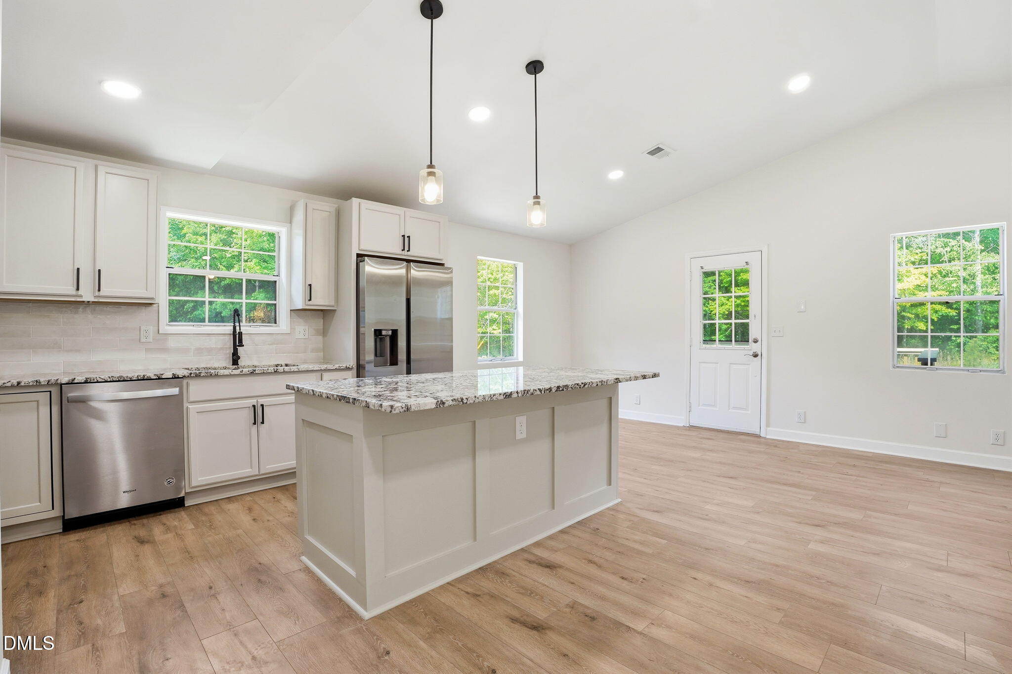 3602 Harrison Road Castalia, NC 27816 - Photo 33 of 48 a kitchen with stainless steel appliances granite countertop a stove a sink dishwasher a refrigerator and a oven with wooden floor