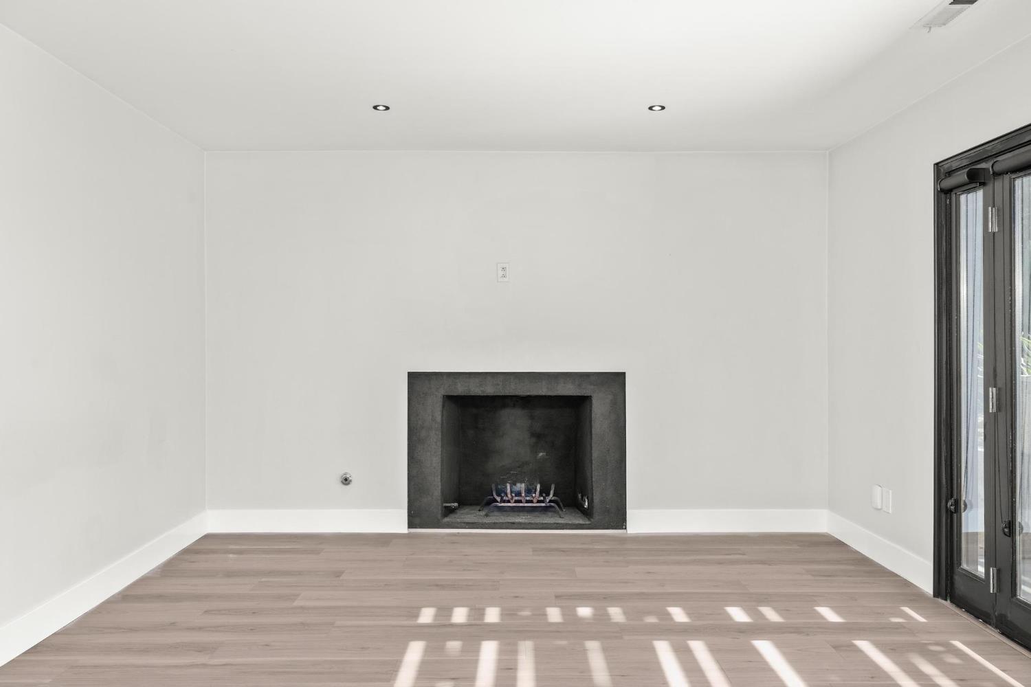 29879 South Chrisman Road Tracy, CA 95304 - Photo 11 of 50 a view of an empty room with a fireplace and a table