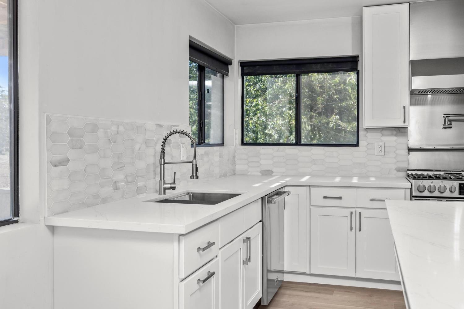 29879 South Chrisman Road Tracy, CA 95304 - Photo 14 of 50 a kitchen with white cabinets a sink and a window