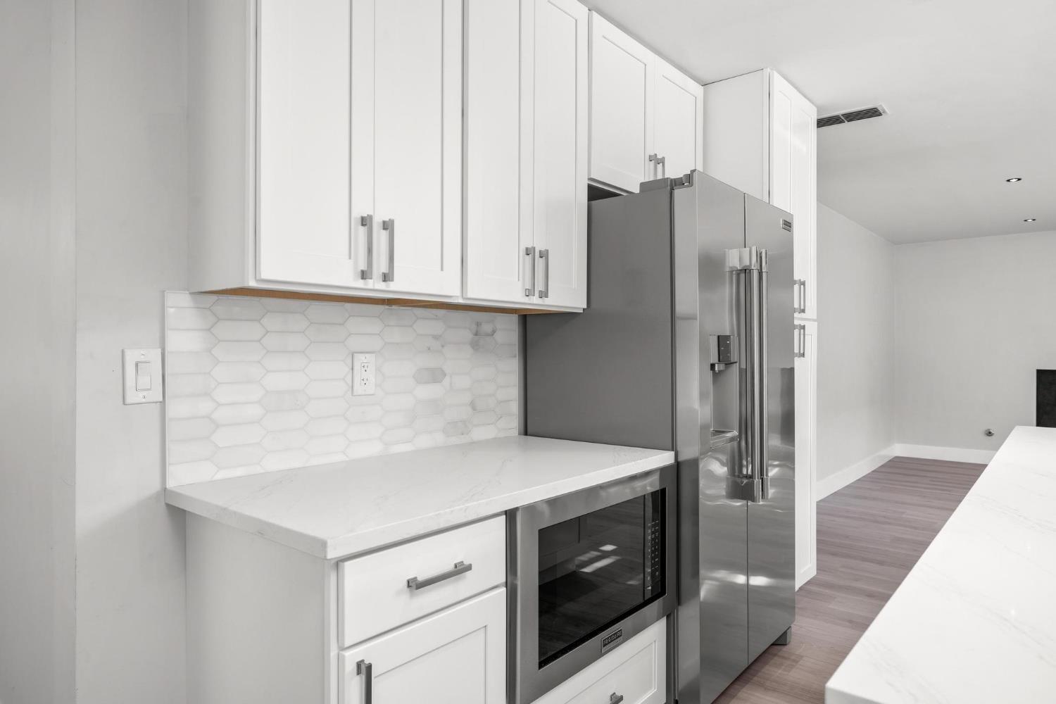 29879 South Chrisman Road Tracy, CA 95304 - Photo 16 of 50 a kitchen with stainless steel appliances white cabinets and a refrigerator