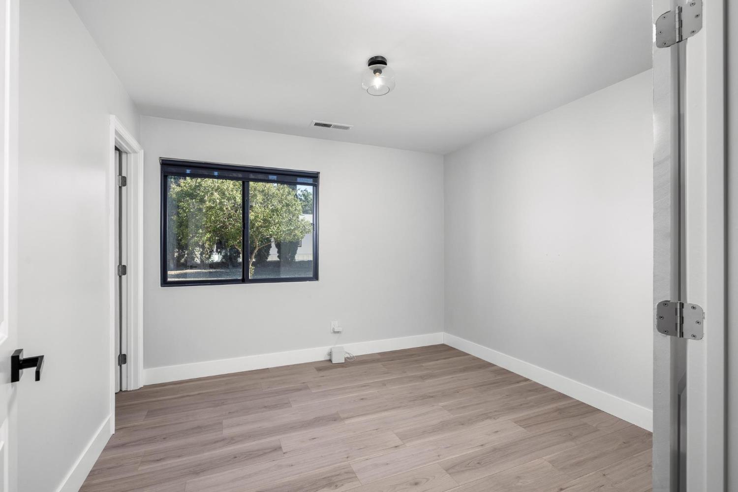 29879 South Chrisman Road Tracy, CA 95304 - Photo 19 of 50 wooden floor in an empty room with a window