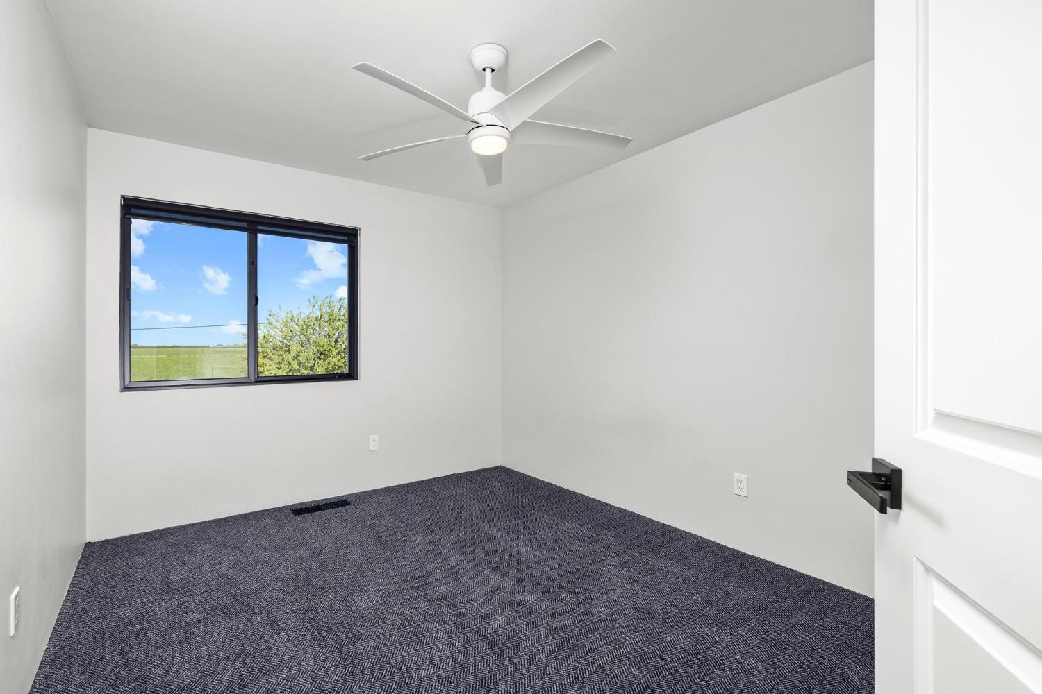 29879 South Chrisman Road Tracy, CA 95304 - Photo 36 of 50 an empty room with a window and a ceiling fan