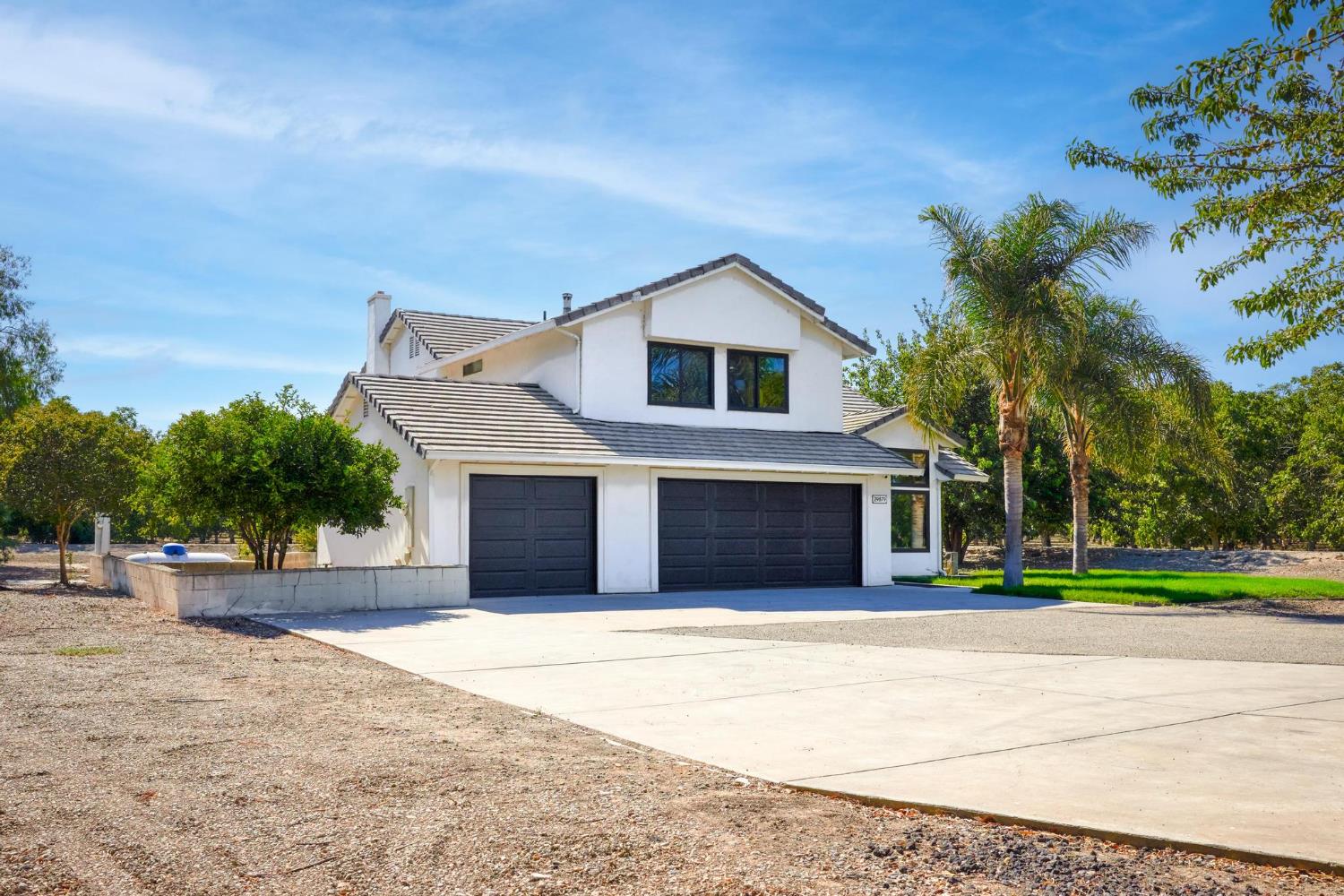 29879 South Chrisman Road Tracy, CA 95304 - Photo 4 of 50 a front view of a house with a yard and garage