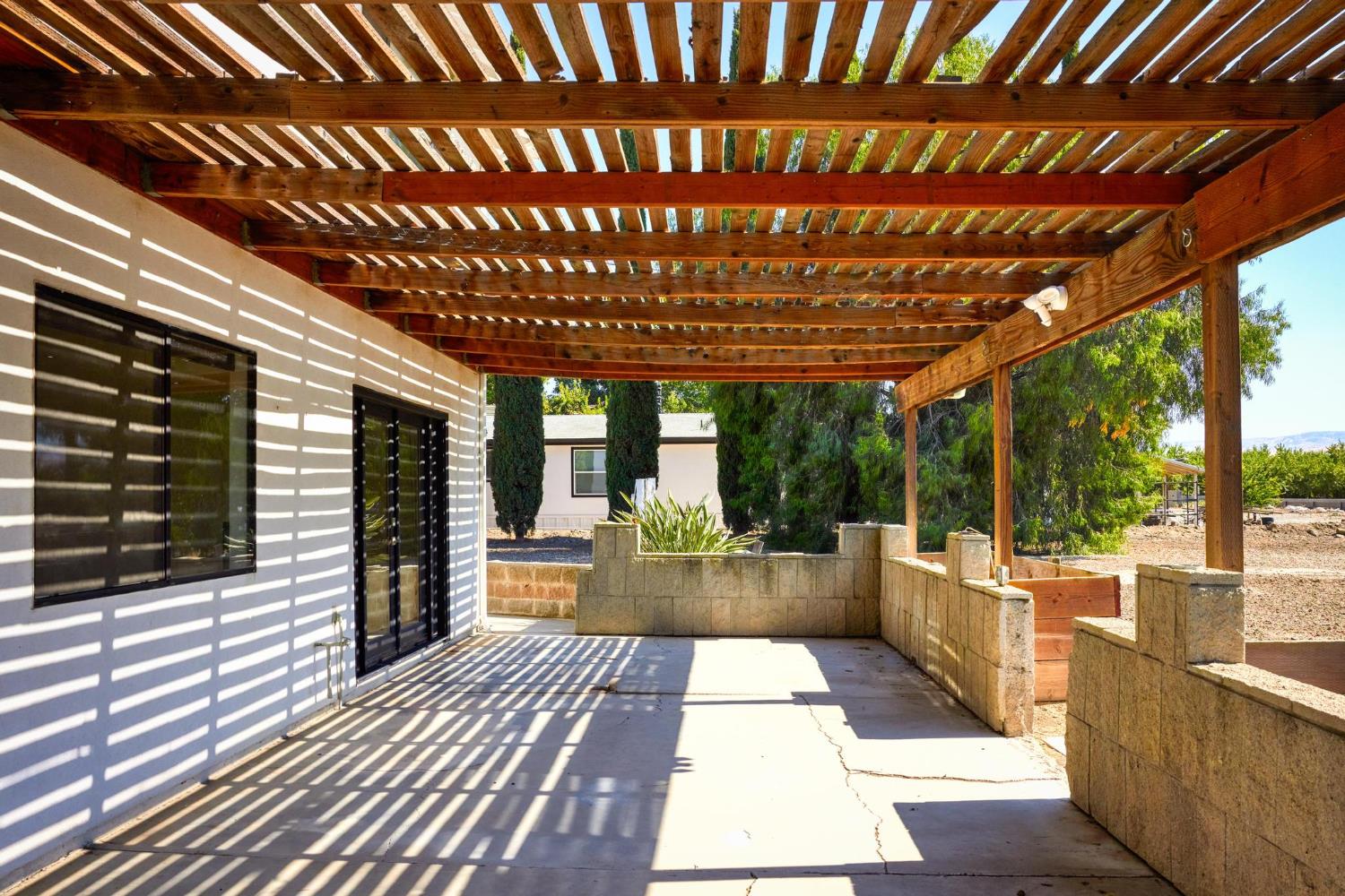 29879 South Chrisman Road Tracy, CA 95304 - Photo 43 of 50 a view of a patio with table and chairs with wooden floor and fence
