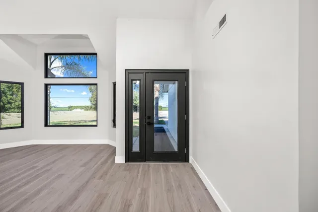 a kitchen with white cabinets a sink and a window