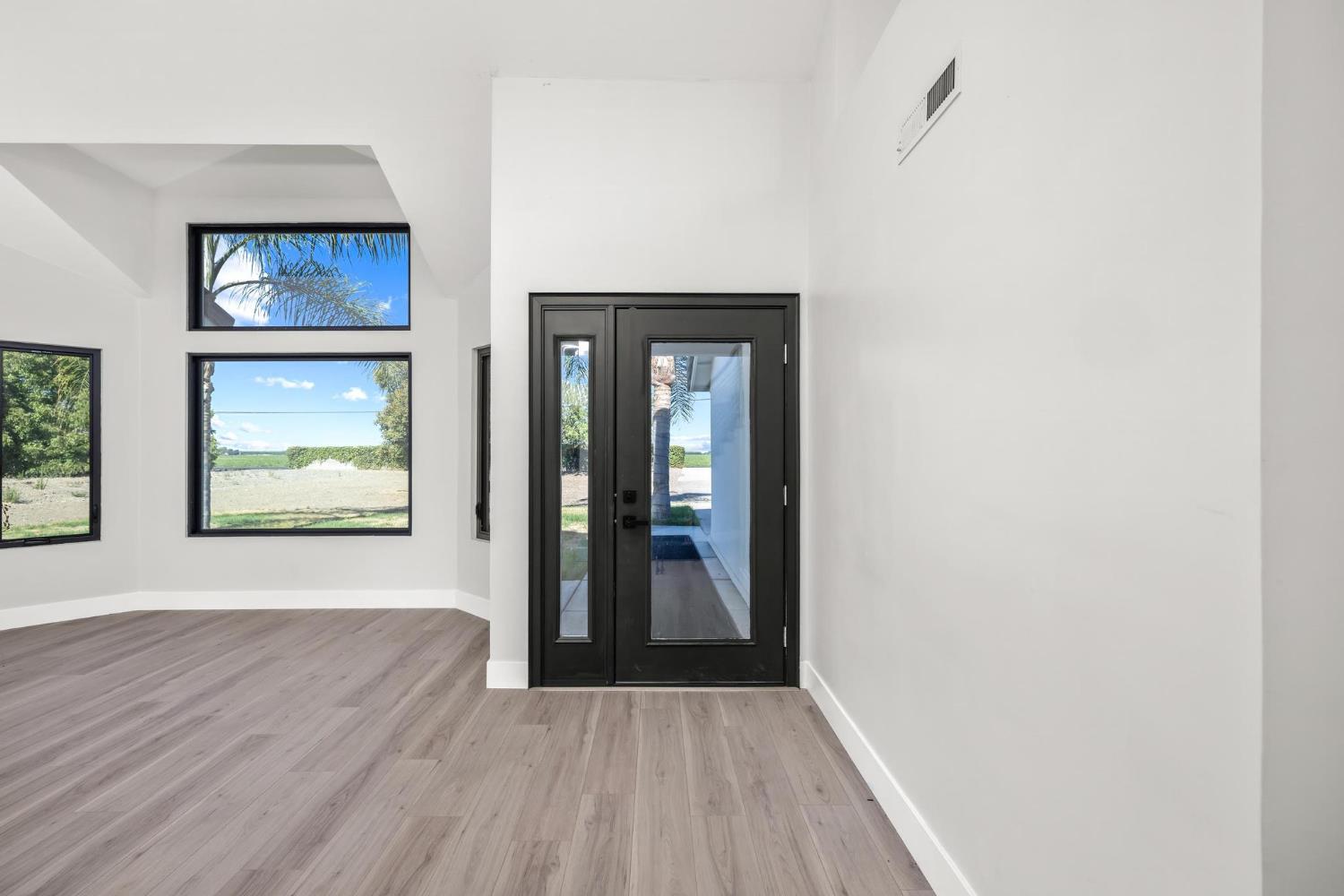 29879 South Chrisman Road Tracy, CA 95304 - Photo 8 of 50 a view of a hallway with wooden floor and a large window