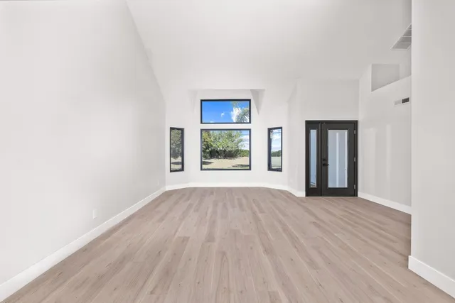 a kitchen with stainless steel appliances white cabinets and a refrigerator