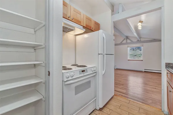 a kitchen with white cabinets and white appliances