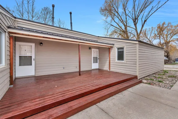 a view of a house with a wooden fence