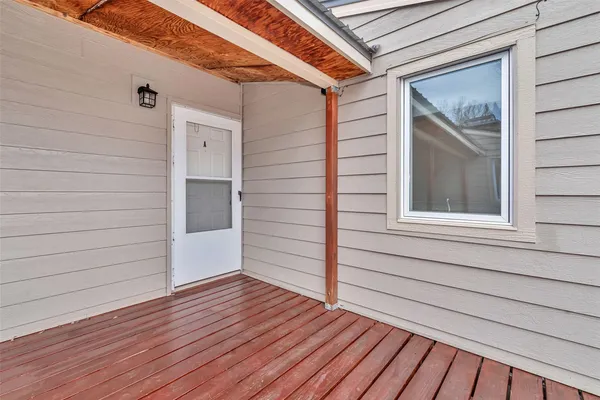 a view of front door and deck of the house