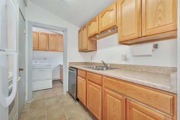 a white stove top oven sitting inside of a kitchen