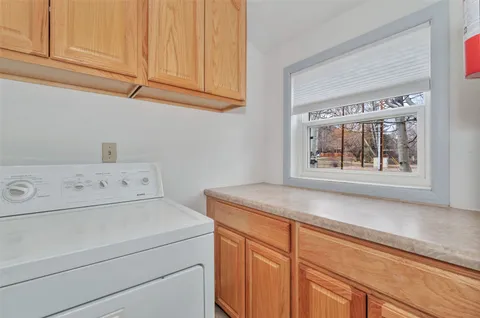 a kitchen with stainless steel appliances granite countertop a sink and a refrigerator