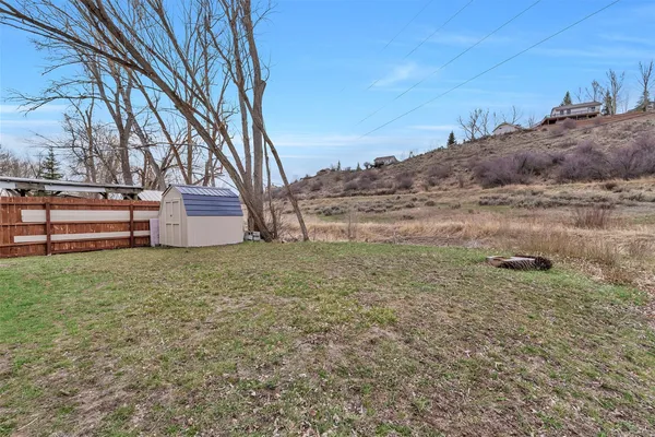 a view of a backyard with large trees