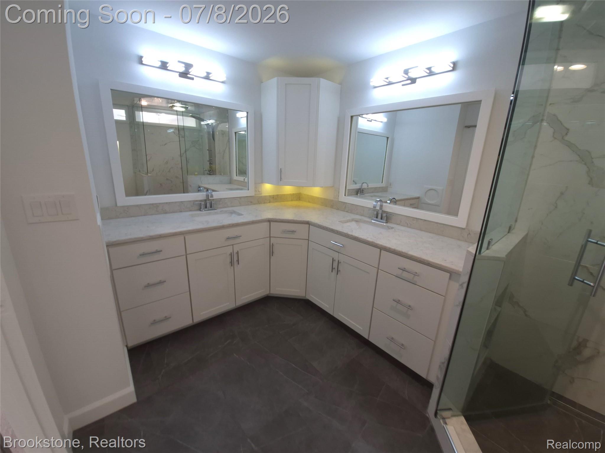 4140 South Henderson Road Davison, MI 48423 - Photo 51 of 98 Corner vanity featuring dual undermount sinks, light-toned countertops, and ample white cabinetry with brushed nickel hardware