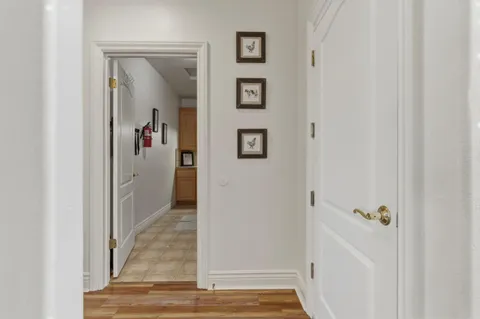 a bed sitting in a spacious bedroom next to a window