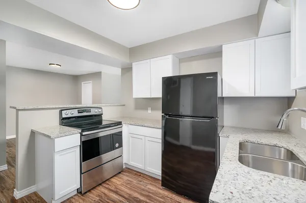 a kitchen with a stove a refrigerator and a sink