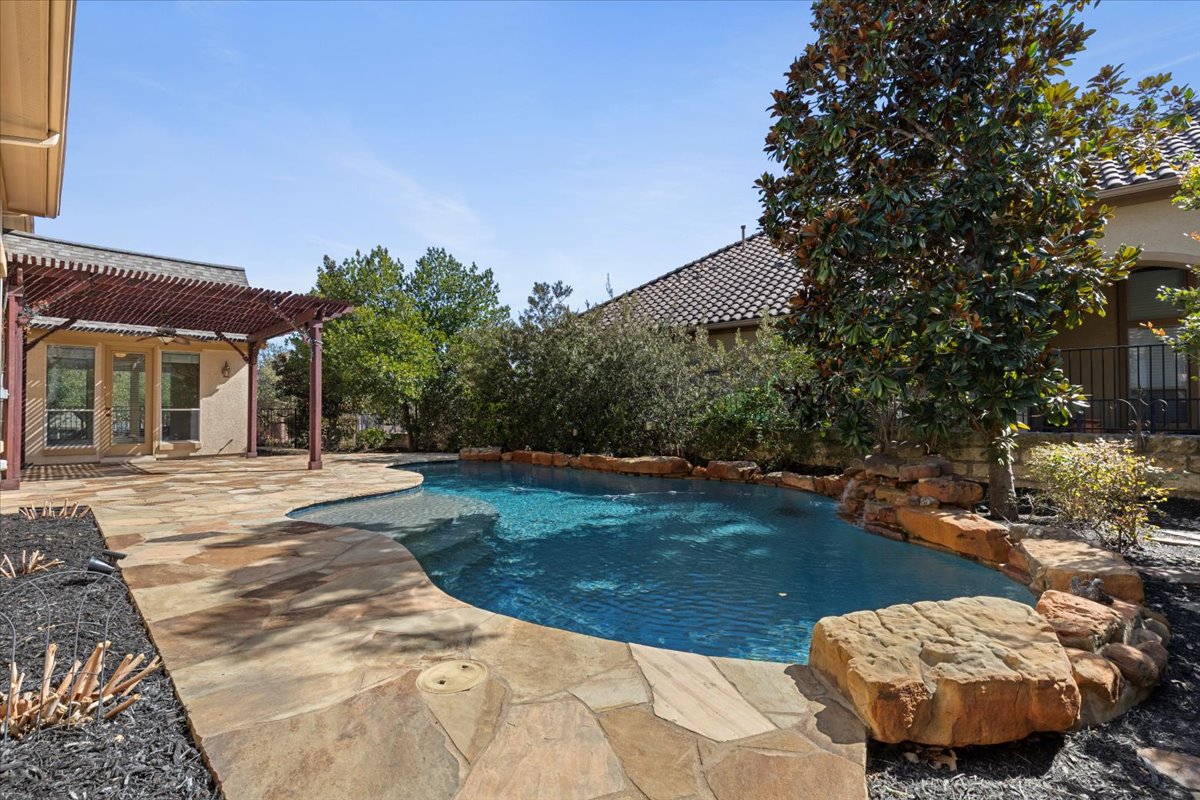 111 Whitley Drive Austin, TX 78738 - Photo 37 of 38 View of swimming pool featuring patio surround, a pergola.