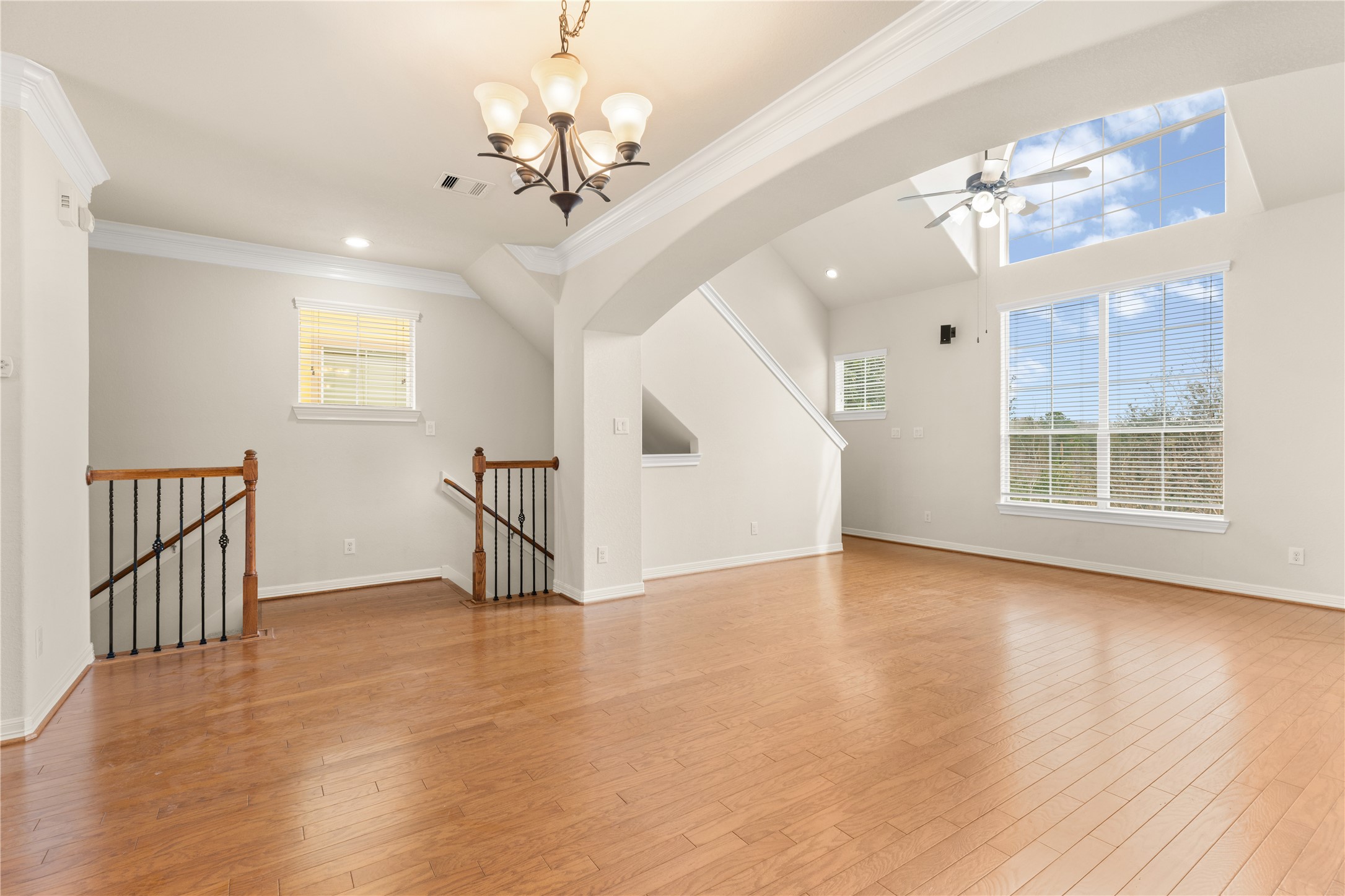 3334 Clearview Villa Way Houston, TX 77025 - Photo 6 of 35 Bright, open living space with hardwood floors, large windows, and high ceiling, Ideal for a modern, airy atmosphere.