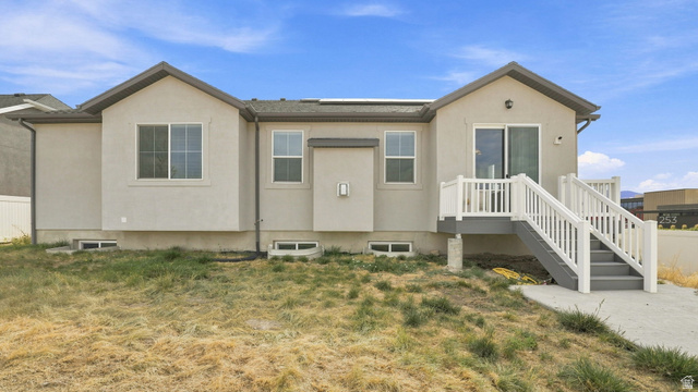 6017 North Sheps Road, Unit C211 Eagle Mountain, UT 84005 - Photo 21 of 25 Rear exterior with stucco finish and multiple windows