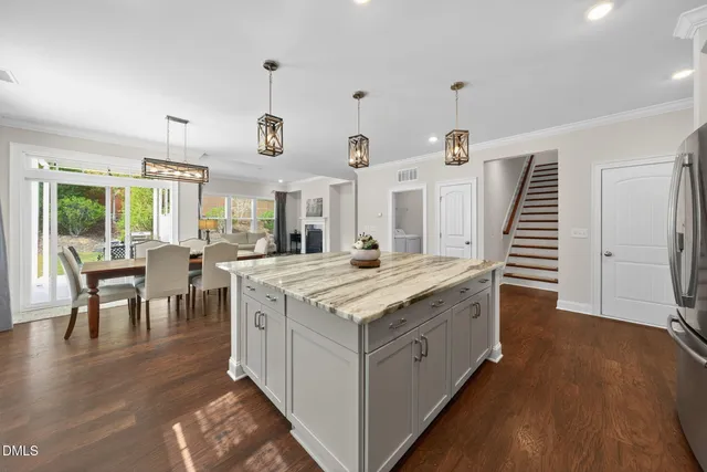 a kitchen with a sink stove and wooden floor