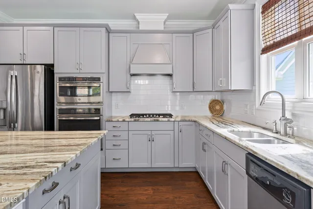 a kitchen with appliances a refrigerator and cabinets