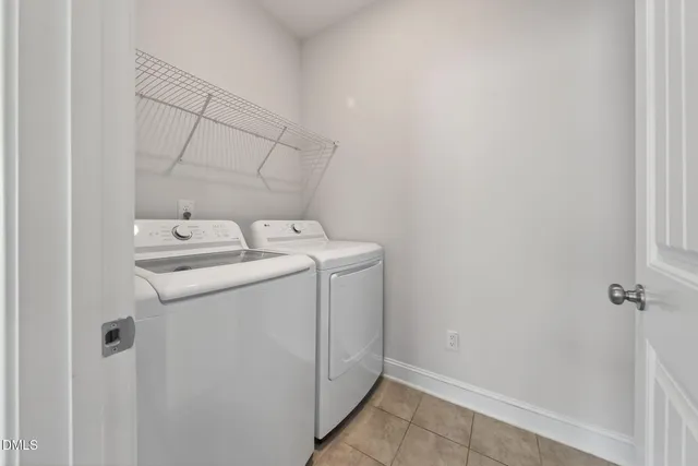 a bedroom with a bed tv and a window