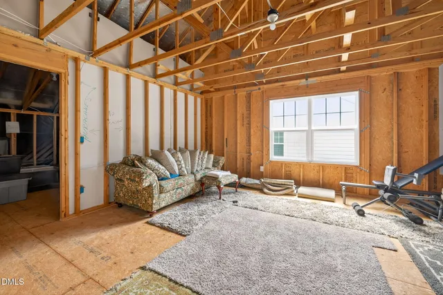 a living room with furniture a flat screen tv and a window