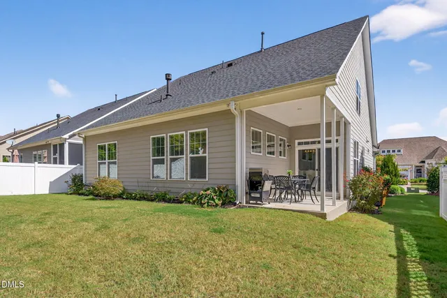 a living room with furniture and large windows