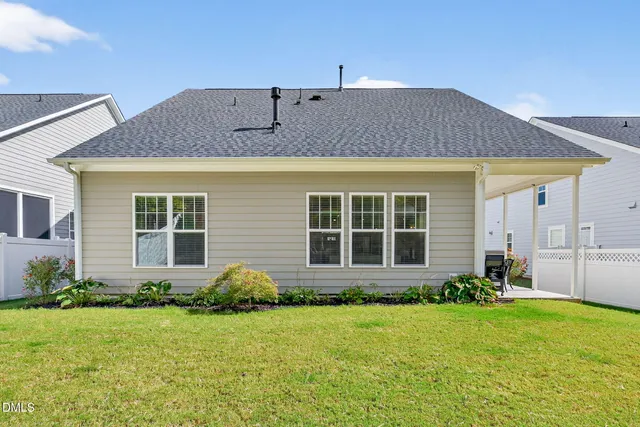a front view of house with yard and outdoor seating